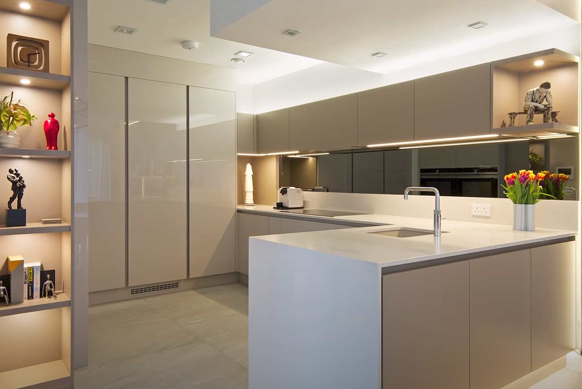 Sleek L-shaped kitchen with sleek cabinets and ligthing fixtures
